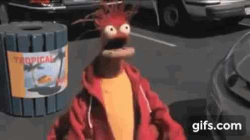 Muppet Standing In Front Of Trash Can With Tropical Sign GIF