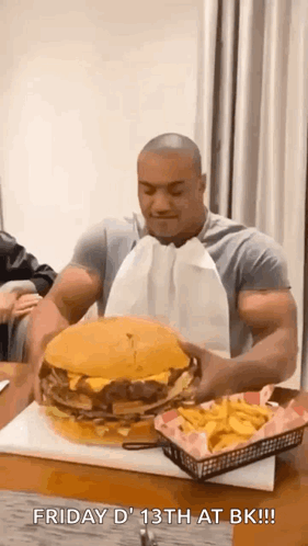 Muscular Man Eating Giant Hamburger and French Fries