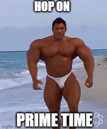 Muscular Man in Bikini Standing on Beach
