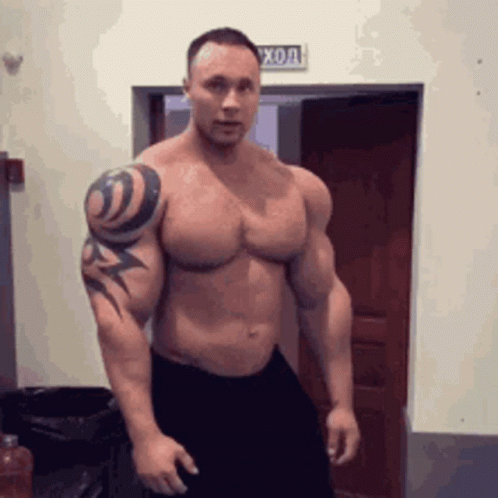 Muscular Man with Tattoo Standing