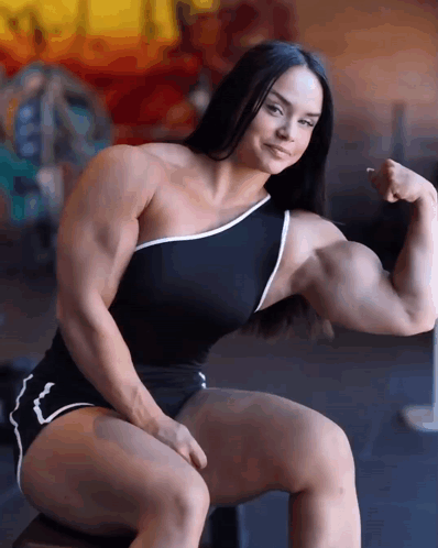 Muscular Woman Sitting and Flexing