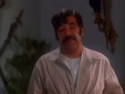 Mustached Man Making Funny Face Dark Room