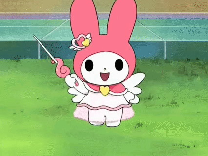 My Melody Is Holding A Wand In Her Hand While Standing On A Lush Green Field . GIF