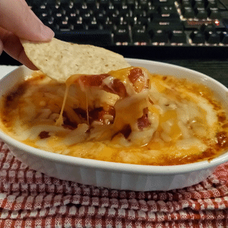 Nacho Chip Dipping In Cheese Sauce GIF