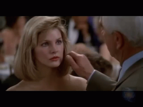 Naked Gun Frank Drebin Pinching Jane Spencer Cheek GIF
