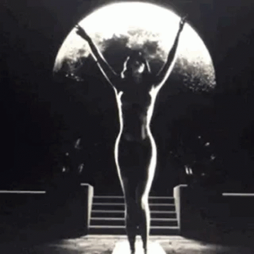 Naked Woman Standing in Front of Full Moon