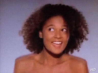 Naked Woman With Curly Hair Smiling GIF