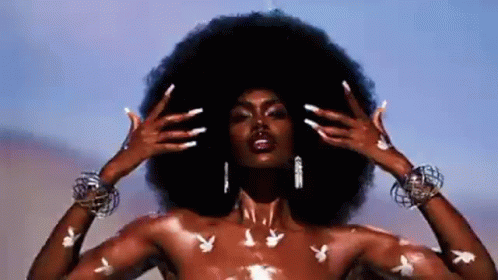 Naked Woman with Large Afro and Playboy Bunny Tattoos