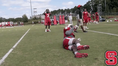 Nc State Player Rolling On Ground GIF