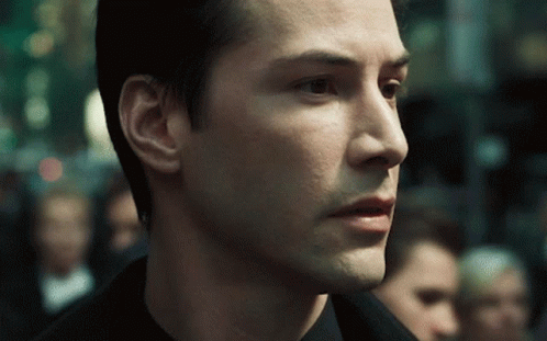 Neo Wearing Shades In Crowded Place In Matrix GIF