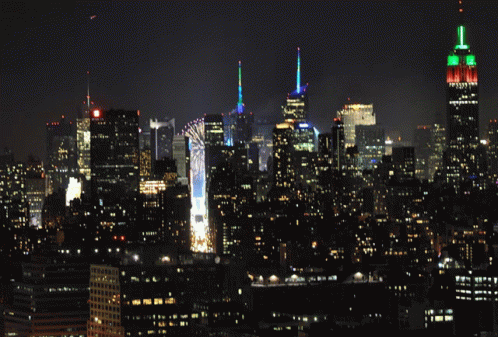 New York City Skyline At Night With The Empire State Building Lit Up GIF