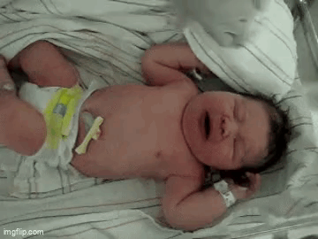 Newborn Baby Crying on Bed