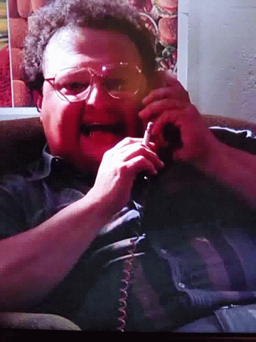Newman Smoking While Talking On Phone GIF