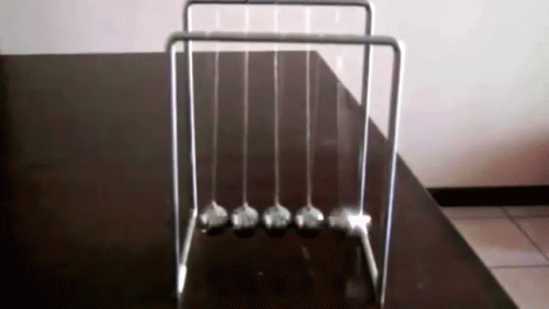 Newton's Cradle On Black Table GIF