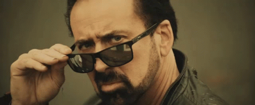 Nic Cage Intense Look Wearing Shades GIF