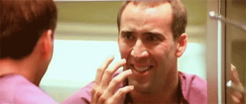 Nicolas Cage Face Off Scene Looking In The Mirror GIF