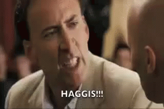 Nicolas Cage Making Funny Face Talking to Man in Crowd
