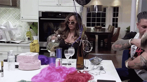 Nicole Polizzi Pouring Two Shots Of Vodka GIF