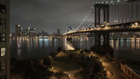 Night Bridge Over Water With City GIF