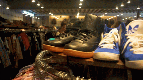 Nike And Adidas Shoes On Shelf GIF