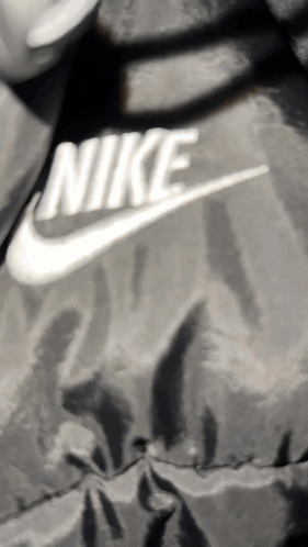 Nike Logo On Black Jacket GIF