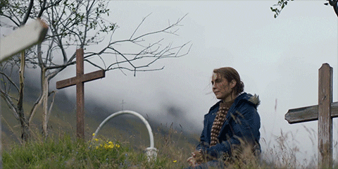 Noomi Rapace Praying To Graveyard Cross GIF