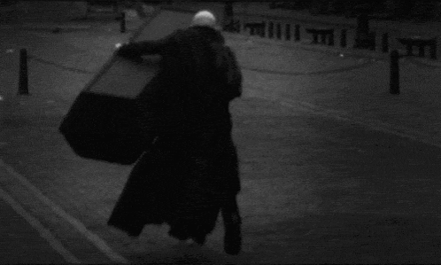 Nosferatu Running And Holding Coffin In Street GIF