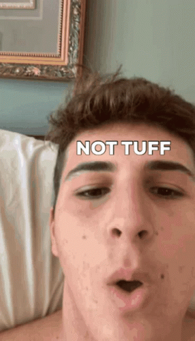 Not Tuff Young Man Lying in Bed