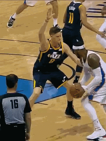 Number 9 Basketball Player Blocking Number 11 Player