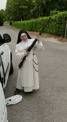 Nun Holding Shotgun Near Car on Roadside