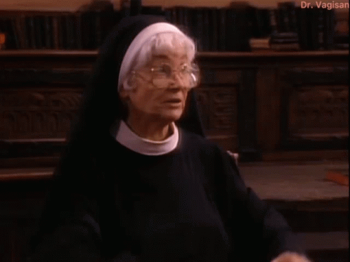 Nun Standing in Front of Bookshelf