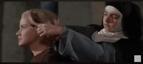 Nun Standing Next To Young Boy In Movie GIF