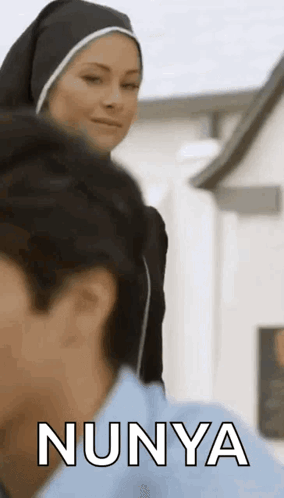 Nun Talking to Man in Blue Shirt