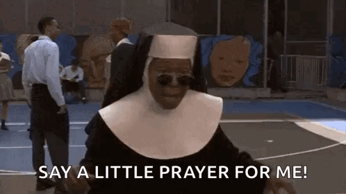 Nun with Sunglasses Saying 'Say a Little Prayer for Me
