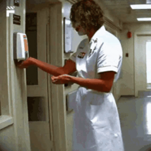 Nurse Using Hand Sanitizer