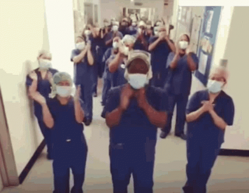 Nurses Clapping in Hospital Hallway