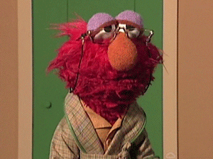 Old Elmo Hit By Rolled Paper GIF