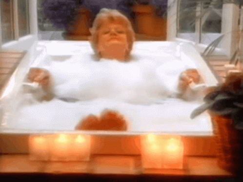 Old Lady Enjoys Bubble Bath With Candles GIF