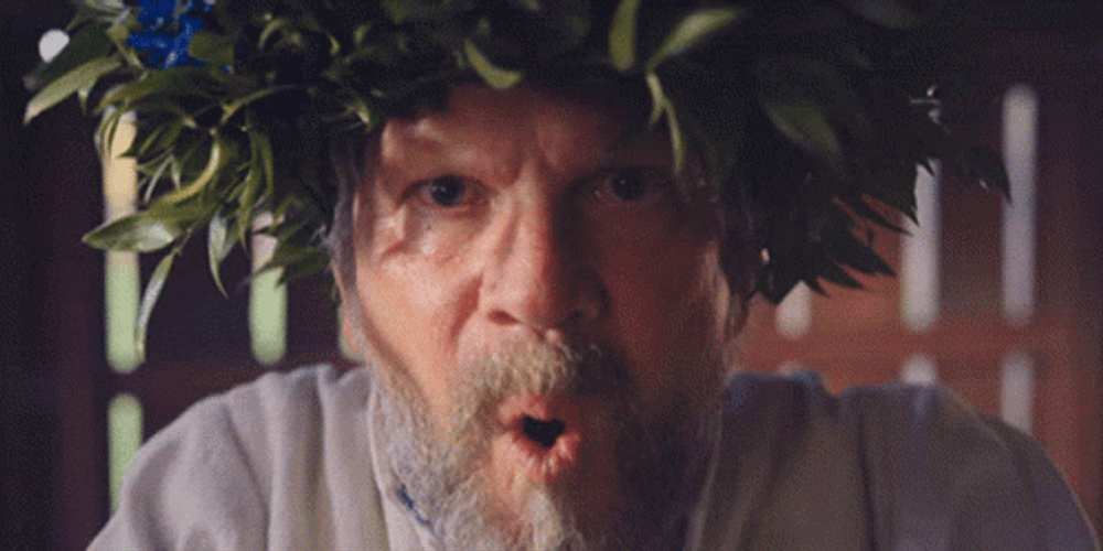 Old Man Blow Sand To Camera GIF