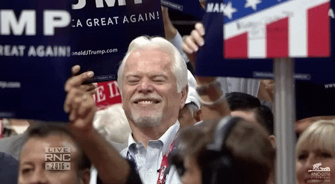 Old Man In Crowd Making Awkward Smile GIF