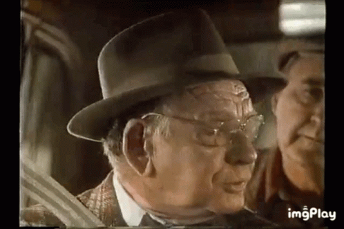 Older Man in Hat Talking to Man in Car