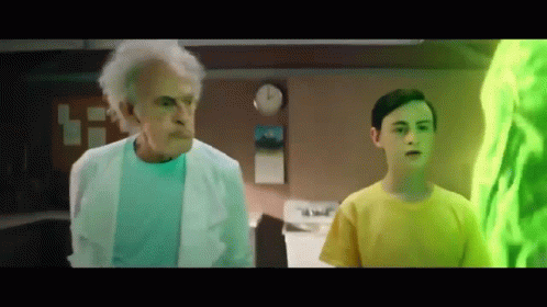 Older Man in Lab Coat Next to Boy in Yellow