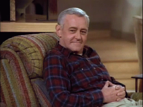 Older Man in Plaid Shirt Sitting in Chair
