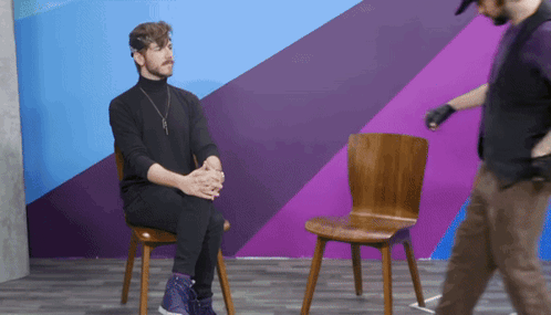 Older Man In Plaid Shirt Sitting In Front Of Prime Logo GIF