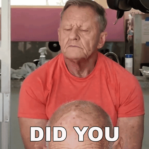 Older Man in Red Shirt Looking at Face Saying Did You