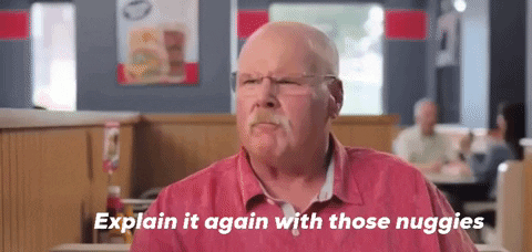 Older Man in Red Shirt Sitting at Diner Table