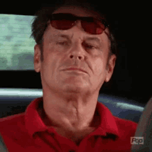 Older Man in Red Shirt Sitting in Car