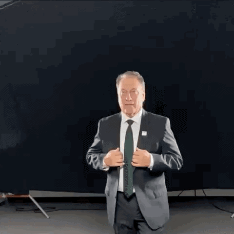 Older Man in Suit and Tie Against Black Background