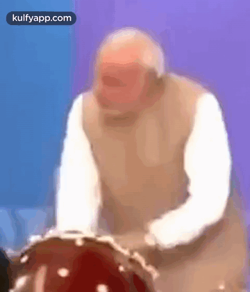 Older Man Playing Drum in Blurry Photo