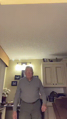 Older Man Standing in Living Room